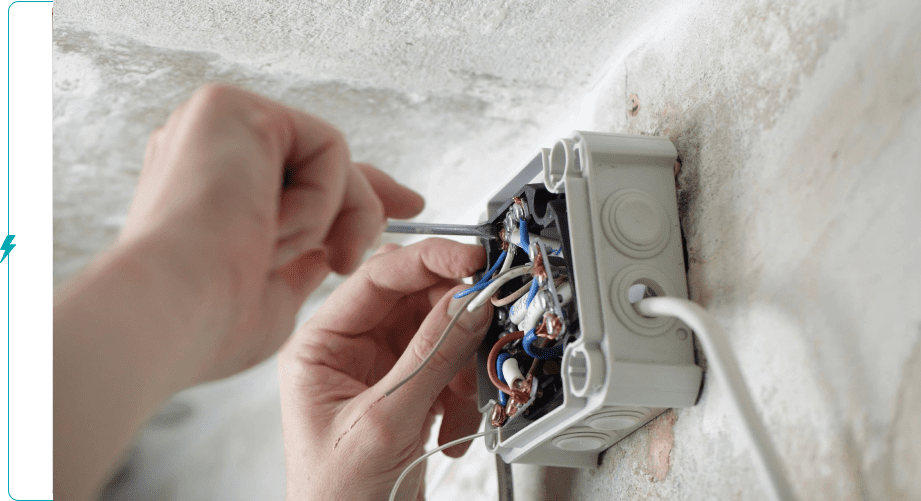 A person is working on an electrical box.