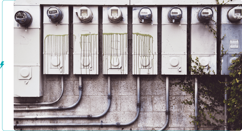 A bunch of electrical meters on the side of a building.