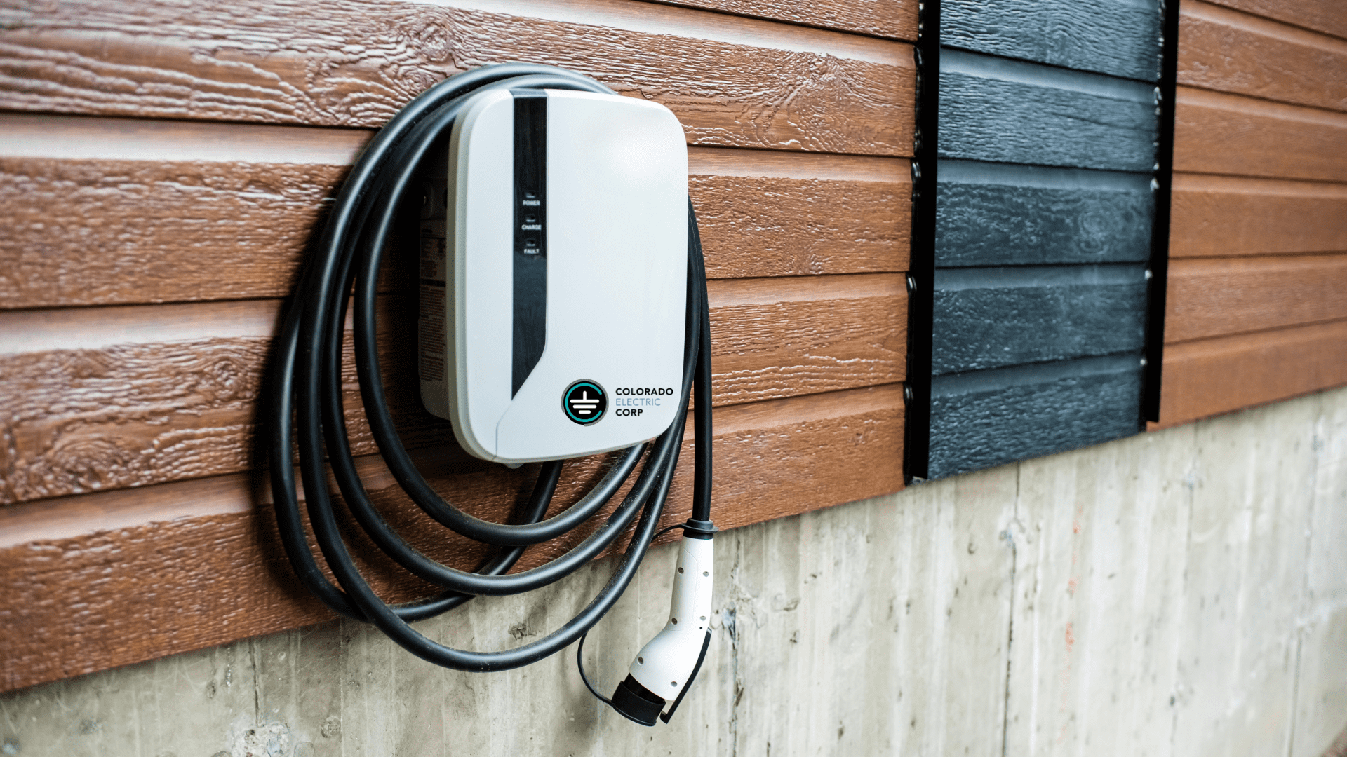 EV Charger installed on outer wall of home near driveway as an example of the home electrical services from Colorado Electric Corp.